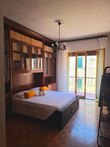 a bedroom with a large bed and a large window at Casa Mecenate in Arezzo