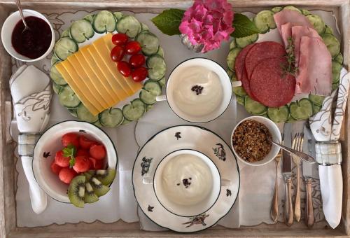 a table topped with plates and bowls of food at Guesthouse Mamaloutje in Bemmel