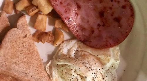 a plate of food with eggs and bread and toast at Holiday Inn Poplar Bluff by IHG in Poplar Bluff