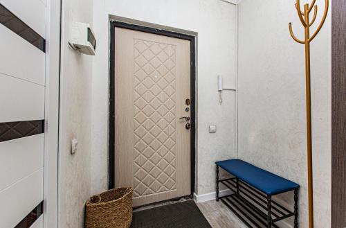 a door with a blue bench in a hallway at BAYHOUSE - Апартаменты в ЖК Уш Сункар in Almaty
