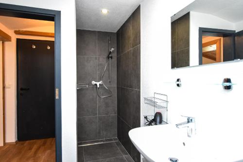 a bathroom with a sink and a shower at Haus an der Ache in Fieberbrunn