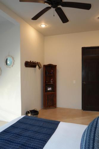 a bedroom with a bed and a ceiling fan at Hotel Boutique La Puerta Azul Beachfront - Adults Only in Holbox Island