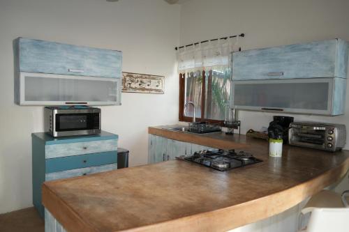 a kitchen with a counter top with a stove at Hotel Boutique La Puerta Azul Beachfront - Adults Only in Holbox Island
