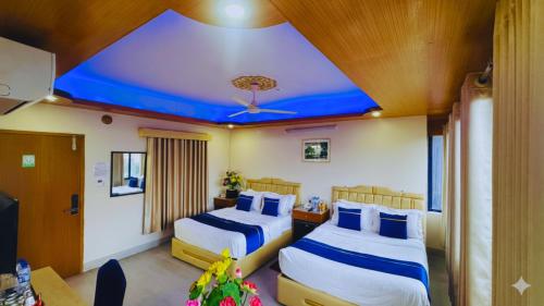 Кровать или кровати в номере The Ambassador Hotel Dhanmondi