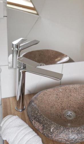 two sinks in a bathroom with a granite sink at Domos Los Molles in Los Molles