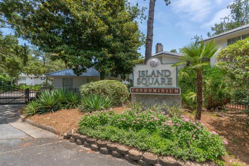 a sign for a island square courthouse in front of a house at Boozie's Bungalow in Saint Simons Island