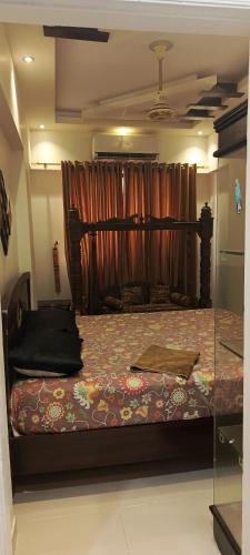 a bedroom with a bed in a room with a curtain at Luxury One Bed Apartment in Karachi in Karachi