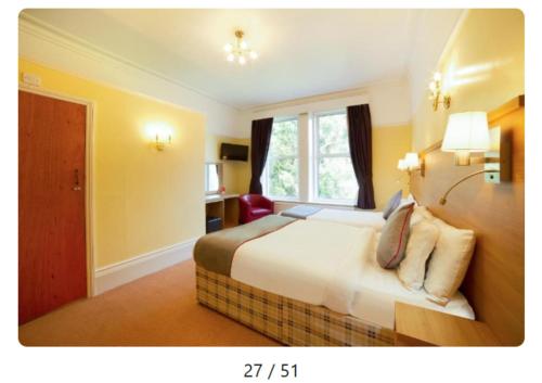 a hotel room with a bed and a window at OYO Eagle House Hotel, St Leonards Hastings in St. Leonards