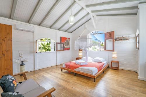 a bedroom with a bed in a room with white walls at Villa Beau Rivage in La Moïse