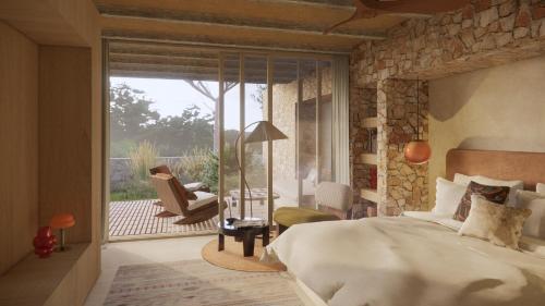a bedroom with a bed and a patio with a chair at Nômade Temple Ibiza in Sineu