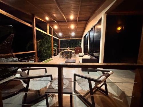 a balcony with chairs and a table in a room at Casa Hachi in Talamanca