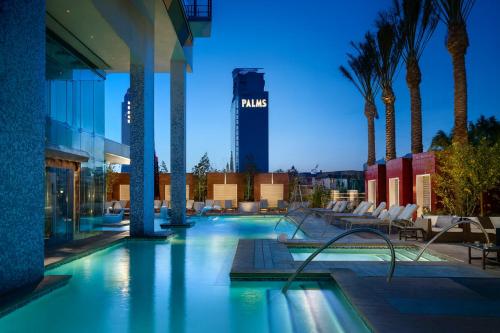 a swimming pool with a hotel in the background at Luxury Suites at Palms Place in Las Vegas