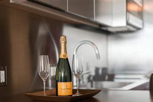 a bottle of champagne and two wine glasses on a table at Luxury Suites at Palms Place in Las Vegas
