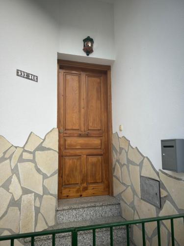 a wooden door in the corner of a building at Casa Alegría in Cómpeta