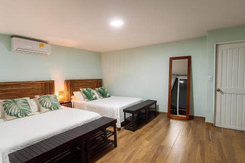 a hotel room with two beds and a window at Fragata Island House in Isla Grande