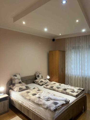 a bedroom with a large bed with pillows on it at Cristian Apartman III Hajdúszoboszló in Hajdúszoboszló