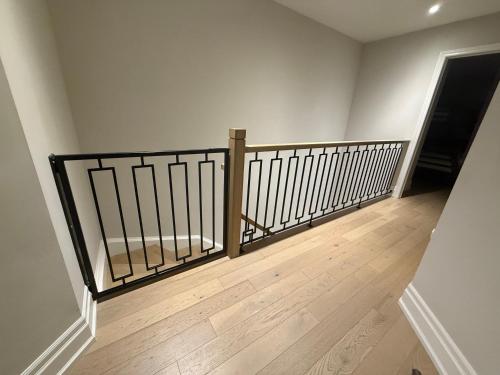 a staircase with a metal railing in a room at Luxury Adventure, Rutherford Go station & Wonderland in Vaughan