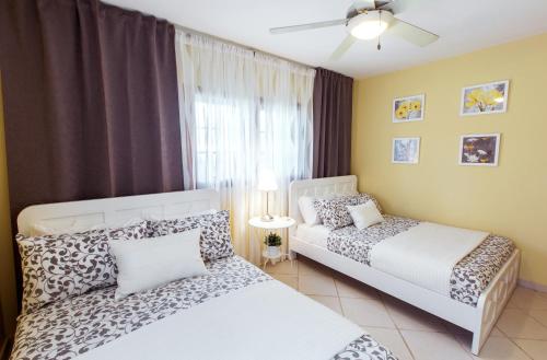 a bedroom with two beds and a window at Condo very close beach in Punta Cana