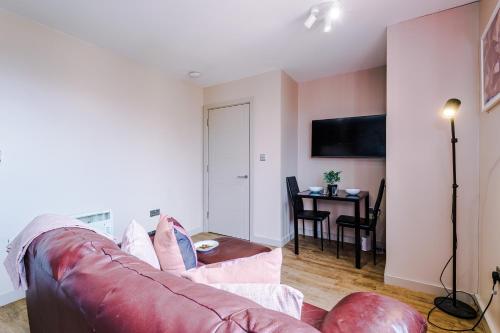a living room with a couch and a table at Modern 2BR near Wigan Town Centre in Wigan