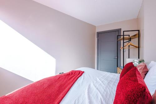 a bedroom with red blankets on a bed at Modern 2BR near Wigan Town Centre in Wigan