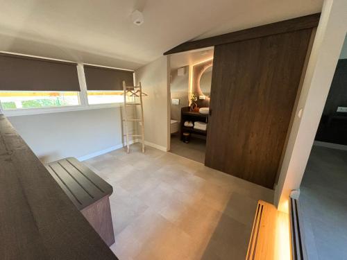 a room with a staircase and a room with a desk at De Meuleberg Boutique Suites 