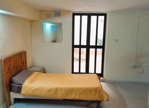 a bedroom with a bed and a large window at Bright & Spacious Private Room, Bathroom & Terrace in Swieqi, Prime Location! in Is-Swieqi