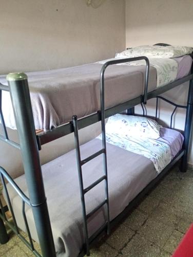 Cama o camas de una habitación en Hostel Trotamundos