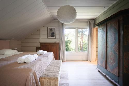 a bedroom with two beds and a large window at Stay North - Västerskog in Västerskog