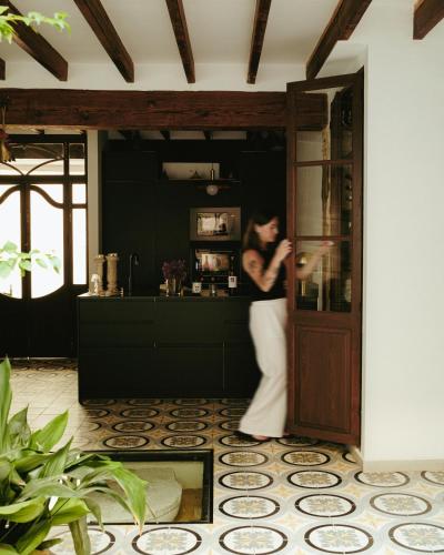 a woman standing behind a door in a room at Ca Sana Teulada Moraira, Grupo Terra de Mar, alojamientos con encanto in Moraira