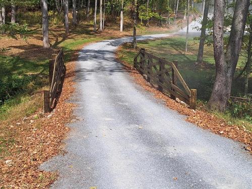 a dirt road with a fence on the side of it at Tranquility Cove in Sugarcreek