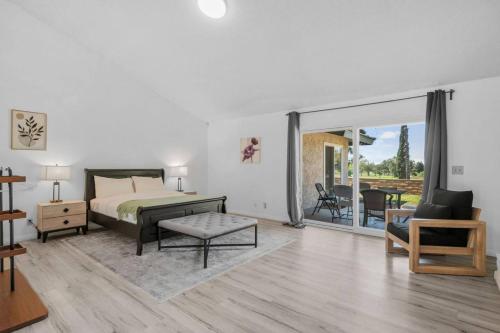 a bedroom with a bed and a living room at Oak and Fairway in Riverside