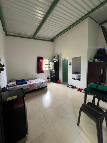 a room with a bed and a table in it at Hotel Yamboró in Pitalito