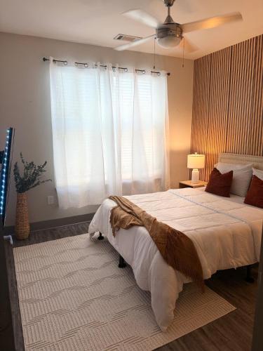 a bedroom with a large bed and a window at Large Buckhead modern suite in Atlanta