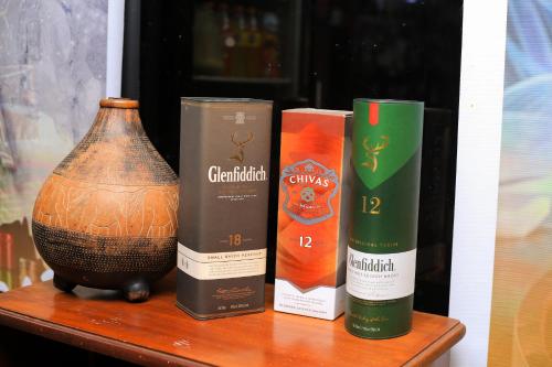 a table with three bottles and a vase on it at LUSHOTO EXECUTIVE LODGE in Lushoto