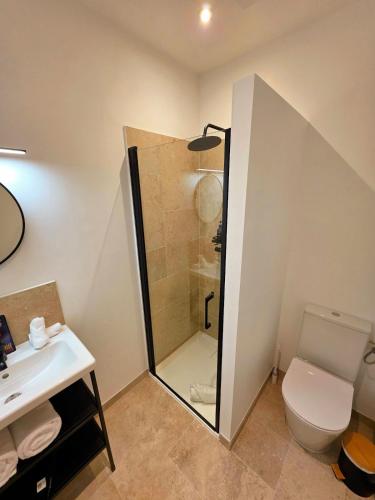 a bathroom with a shower and a toilet and a sink at L'appartement 6 by Vindihouses in Ressille
