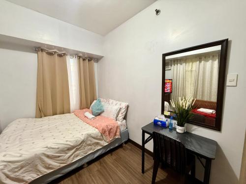 a small bedroom with a bed and a mirror at 1BR LaVerti Cloud Nine Suite Family Affordable Staycation in Manila
