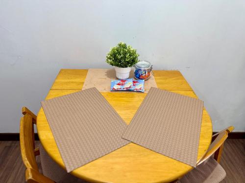 a wooden table with a plant on top of it at 1BR LaVerti Cloud Nine Suite Family Affordable Staycation in Manila