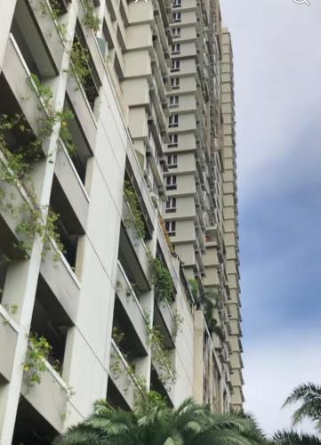 an apartment building with plants on the side of it at 1BR LaVerti Cloud Nine Suite Family Affordable Staycation in Manila