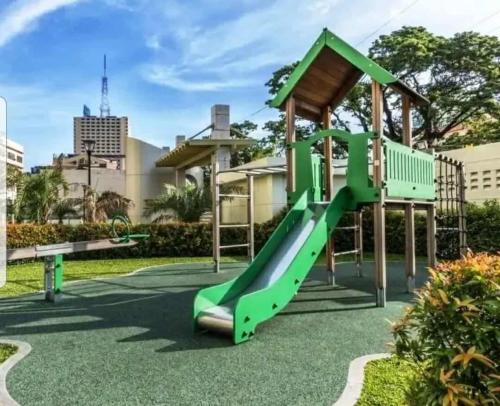 a playground with a slide in a park at 1BR LaVerti Cloud Nine Suite Family Affordable Staycation in Manila