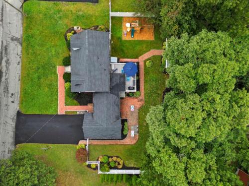 an overhead view of a house with a yard at Stylish Stoneham Getaway Playground Game Room in Stoneham