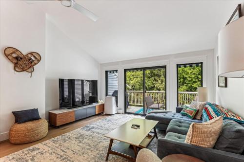 a living room with a couch and a table at Rivercourt Condo D2 in Stowe
