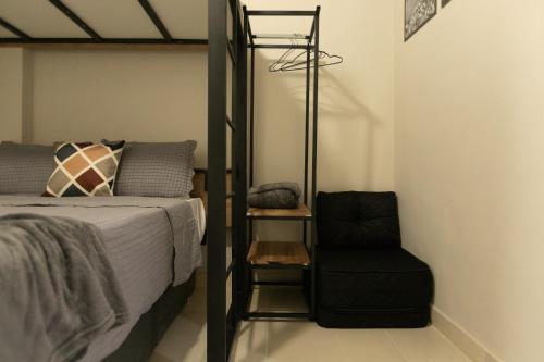 a bedroom with a bunk bed and a black chair at SUH Flamengo 14 Modern Studio in Rio de Janeiro