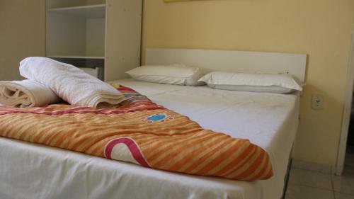 A bed or beds in a room at Encantos Pousada