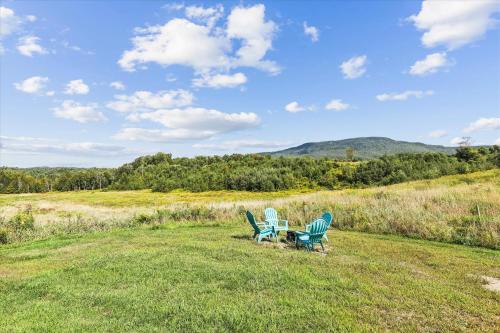 two chairs and a table in the middle of a field at Maple Fox in Morrisville