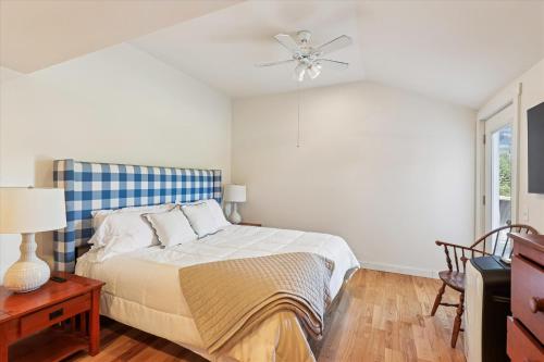a bedroom with a bed and a ceiling fan at Maple Fox in Morrisville