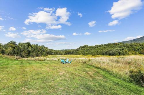 a green field with a bench in the grass at Maple Fox in Morrisville