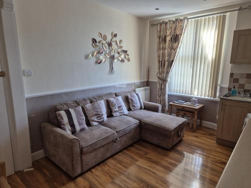 a living room with a couch and a table at Appletorre House Holiday Flats - Pet Friendly by arrangement and Private Parking in Torquay