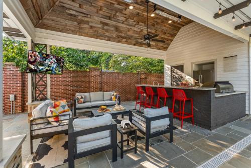an outdoor patio with a bar and a grill at Pool Outdoor TV Fire Pit Game Room in Memphis