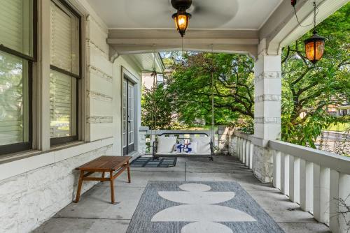 a porch with a bench and a table at Pool Outdoor TV Fire Pit Game Room in Memphis