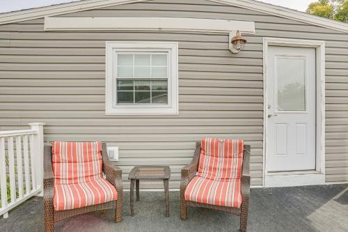 two chairs and a table in front of a house at Dock, Deck and Fire Pit! Chautauqua Lake Retreat in Ashville